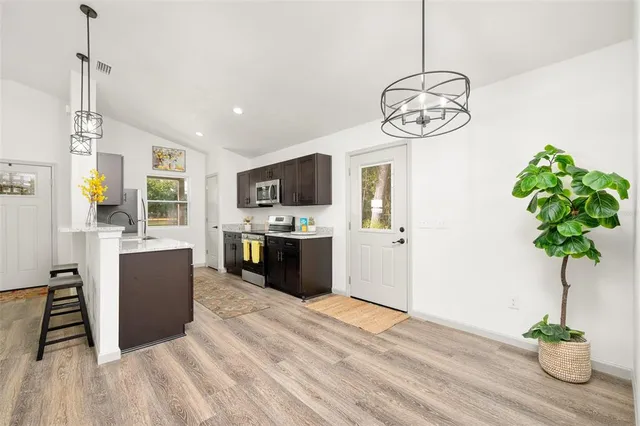 a view of a room with furniture and a chandelier