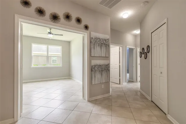 a view of a hallway with wooden floor and windows