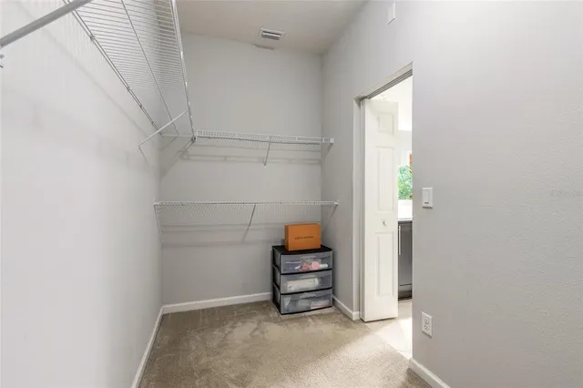 a bedroom with a large bed and a large mirror