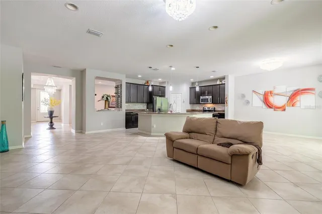 a kitchen with stainless steel appliances granite countertop a sink a stove and a refrigerator