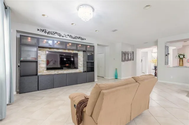 a large kitchen with stainless steel appliances kitchen island granite countertop a large counter top and a stove top oven with wooden floor