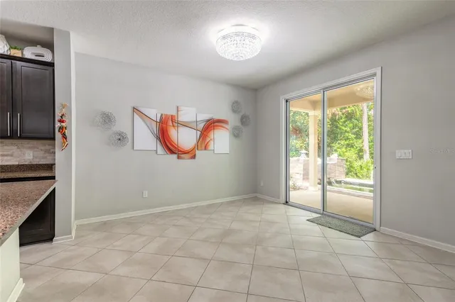 a large kitchen with kitchen island a large counter top stainless steel appliances and cabinets