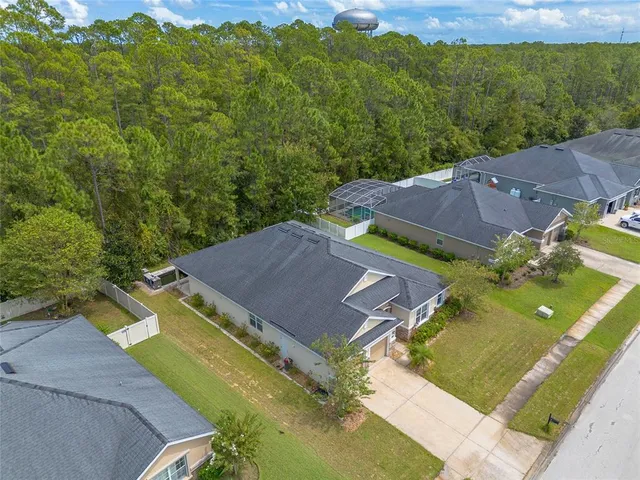 an aerial view of residential houses with outdoor space and swimming pool