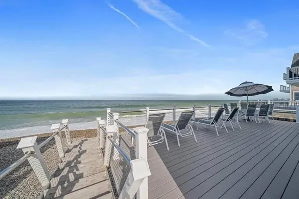 a view of a chairs and table on the wooden floor with a lake