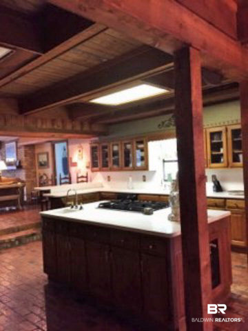 3961 Victoria Drive Theodore, AL 36582 - Photo 4 of 25 Chefs Kitchen. Double sinks with a prep sink in the island. Fireplace in the converted pizza oven, gas cooktop with wall ovens.