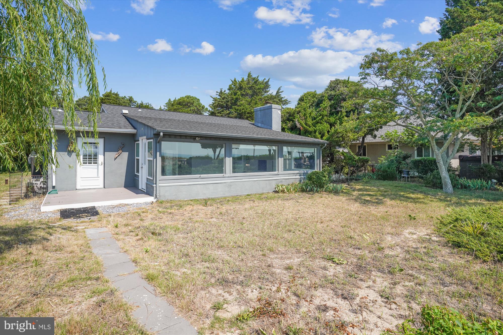 3143 Calvert Boulevard Lusby, MD 20657 - Photo 11 of 36 a house with trees in the background