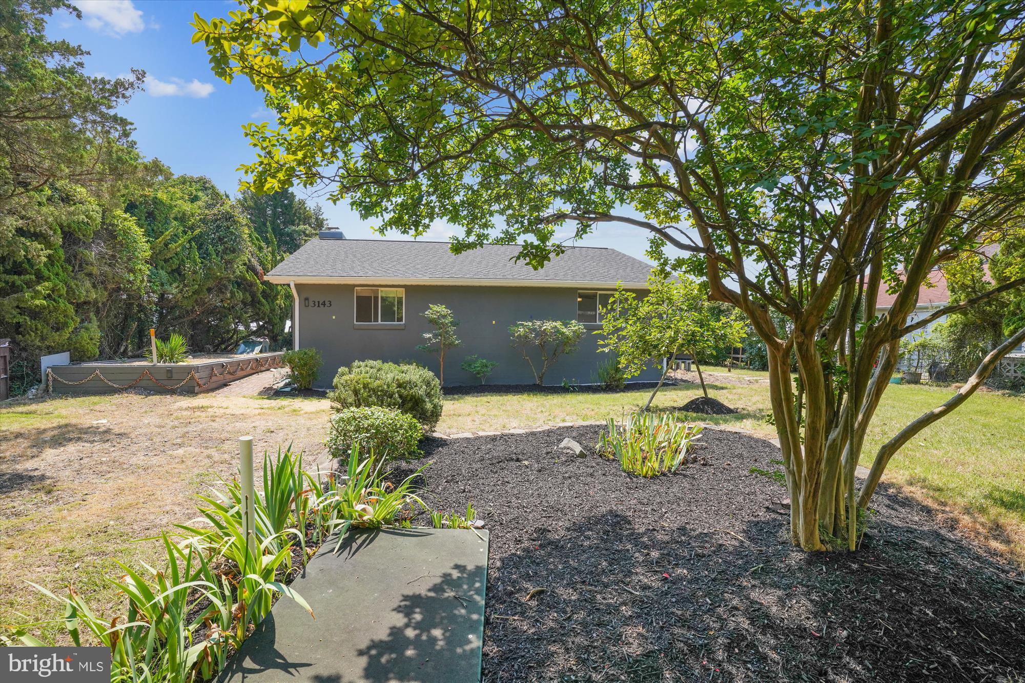3143 Calvert Boulevard Lusby, MD 20657 - Photo 15 of 36 a view of a house with large trees
