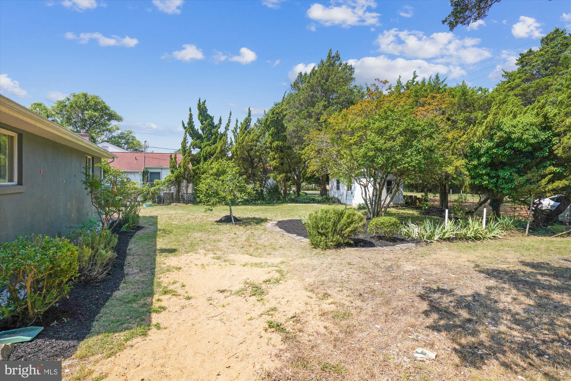3143 Calvert Boulevard Lusby, MD 20657 - Photo 17 of 36 a view of a yard with plants and a fountain