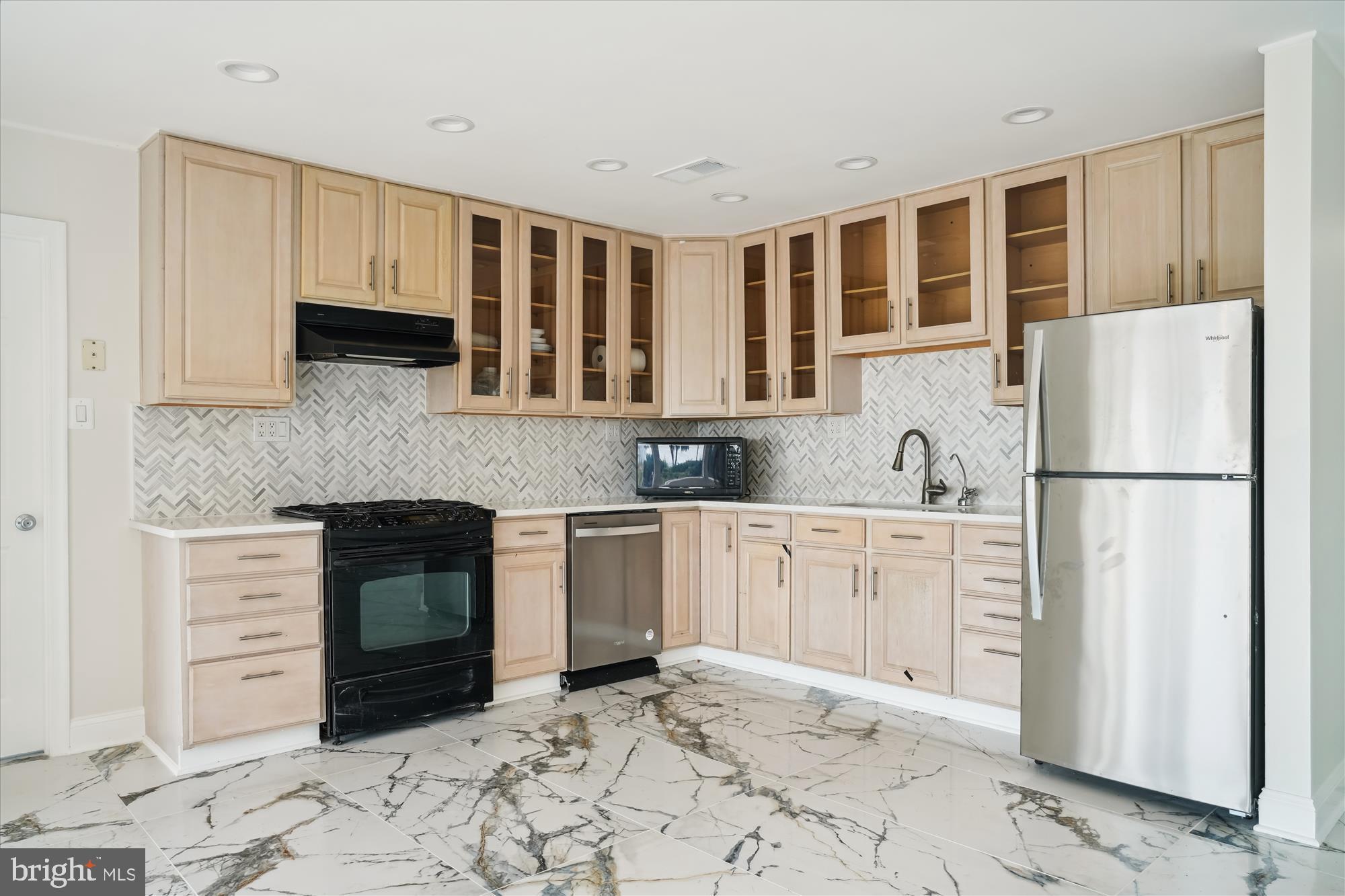 3143 Calvert Boulevard Lusby, MD 20657 - Photo 24 of 36 a kitchen with granite countertop a refrigerator sink and cabinets