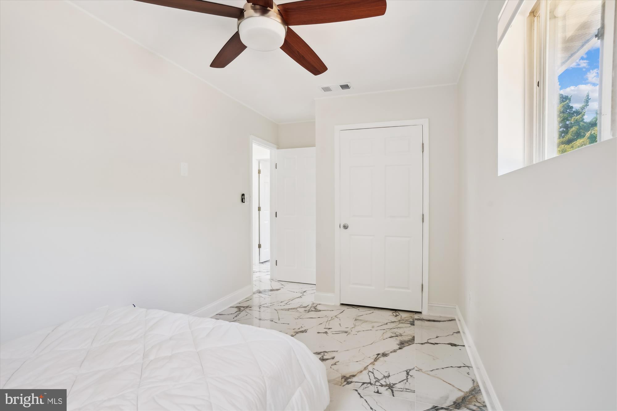 3143 Calvert Boulevard Lusby, MD 20657 - Photo 31 of 36 a bedroom with a bed and a window