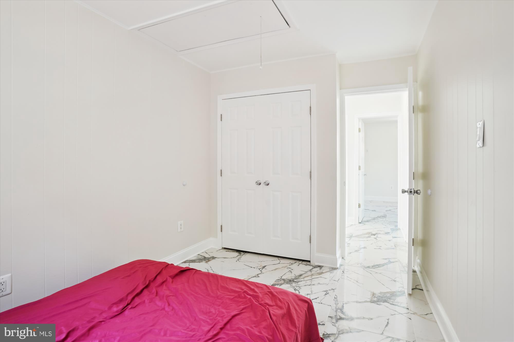 3143 Calvert Boulevard Lusby, MD 20657 - Photo 32 of 36 a bedroom with a bed and a mirror