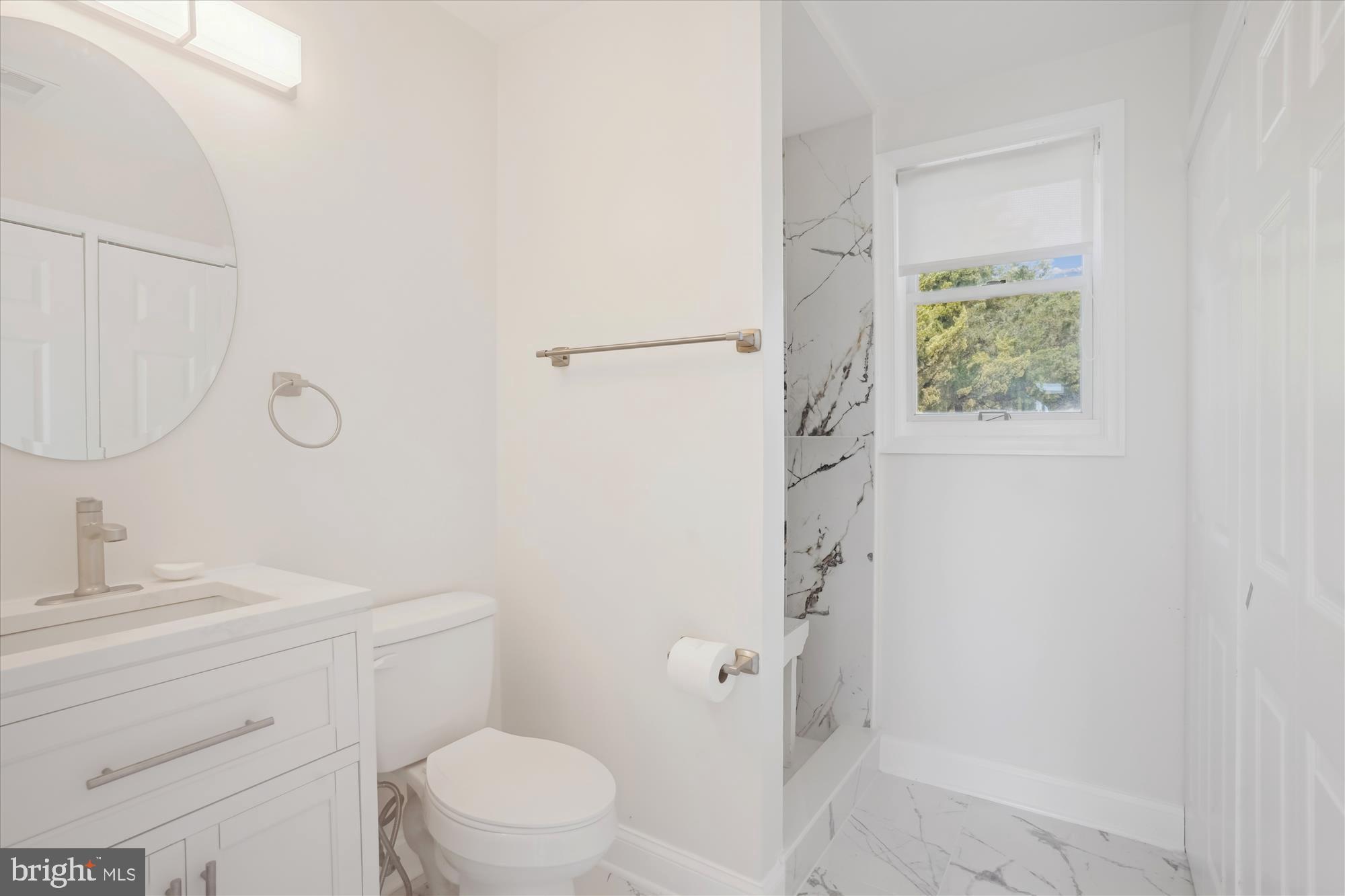 3143 Calvert Boulevard Lusby, MD 20657 - Photo 34 of 36 a bathroom with a sink a toilet and shower