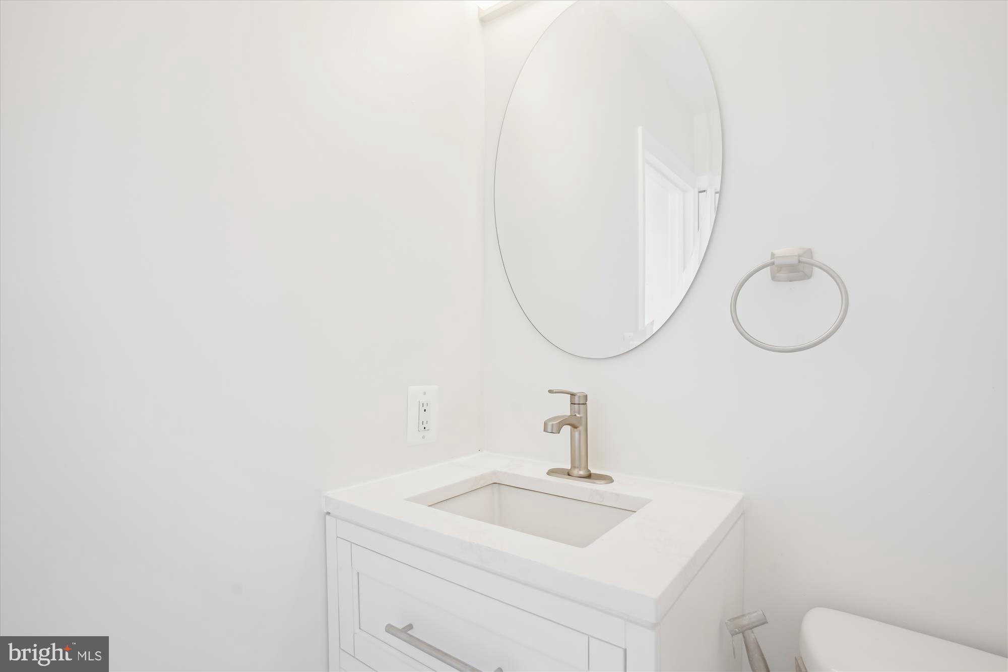 3143 Calvert Boulevard Lusby, MD 20657 - Photo 35 of 36 a bathroom with a sink and a mirror