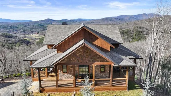 a front view of a house with swimming pool and sitting area
