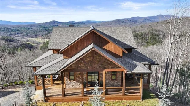a front view of a house with swimming pool and sitting area