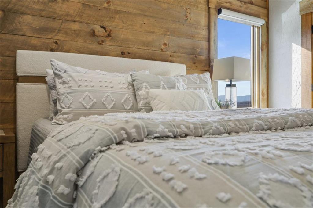 226 Round Top Road Mineral Bluff, GA 30559 - Photo 14 of 78 a bed with white sheets and pillows