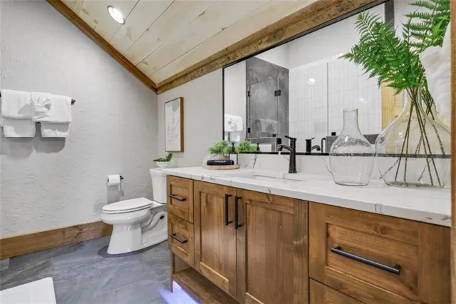 a bathroom with a toilet sink and mirror