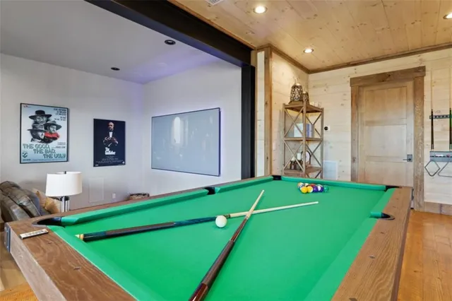 a bathroom with a granite countertop sink a potted plant and a shower
