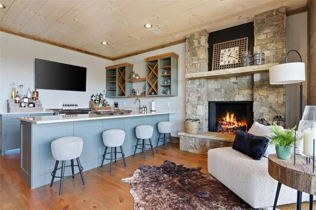 a kitchen with stainless steel appliances granite countertop a sink a stove and a wooden cabinets