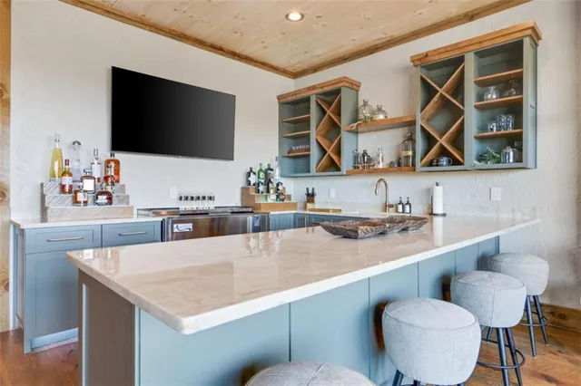 a kitchen with stainless steel appliances granite countertop a sink and a refrigerator