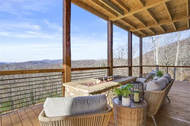 a bedroom with a bed and large windows