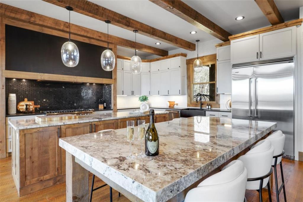 226 Round Top Road Mineral Bluff, GA 30559 - Photo 40 of 78 a kitchen with stainless steel appliances granite countertop a sink a stove and a wooden cabinets