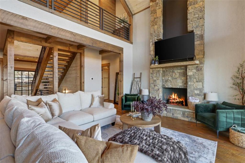 226 Round Top Road Mineral Bluff, GA 30559 - Photo 57 of 78 a living room with furniture a flat screen tv and a fireplace