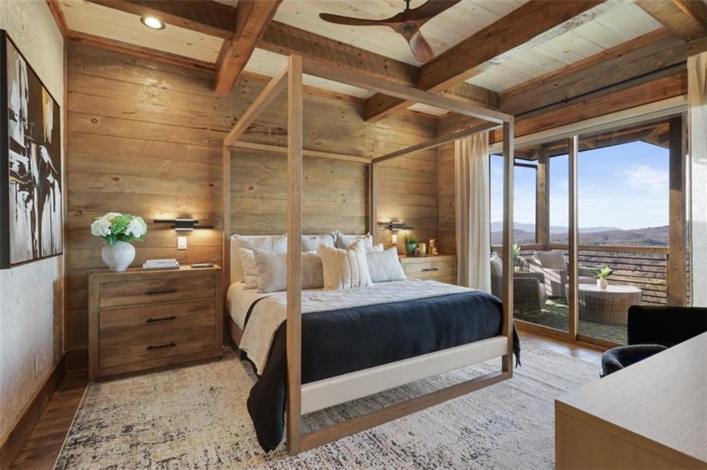 226 Round Top Road Mineral Bluff, GA 30559 - Photo 62 of 78 a bedroom with a bed and large windows