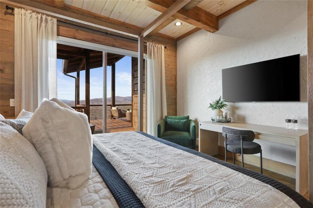 226 Round Top Road Mineral Bluff, GA 30559 - Photo 65 of 78 a bedroom with a bed and a flat screen tv