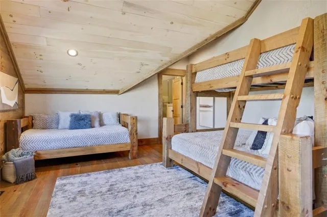 a bed with white sheets and pillows