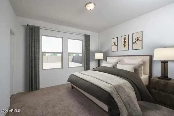 a bedroom with a bed and a lamp on table