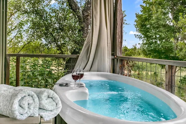 a living room with furniture a fireplace and kitchen view