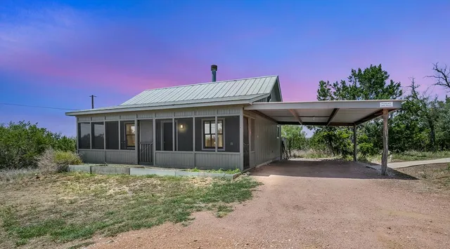 a white bath tub sitting in front of a house