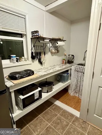a view of washer and dryer with kitchen in the background