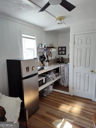 a view of kitchen with sink and refrigerator