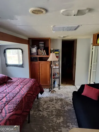 a bedroom with bed and a window