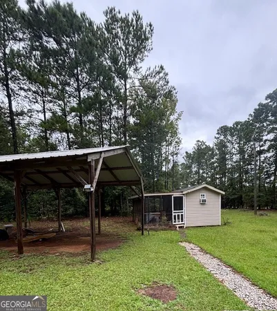 a backyard of a house with table and chairs