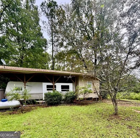 a view of house with backyard space and garden
