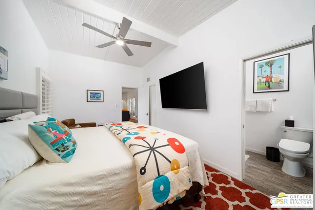 a kitchen with stainless steel appliances kitchen island granite countertop a table chairs in it and a view of living room