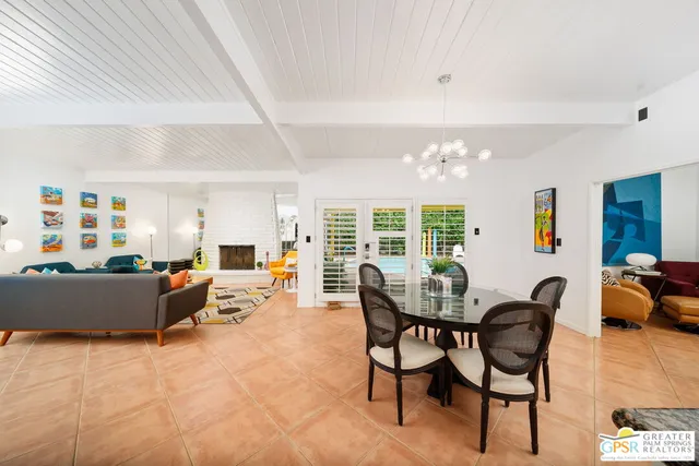 a large kitchen with granite countertop a large counter top space appliances and a window