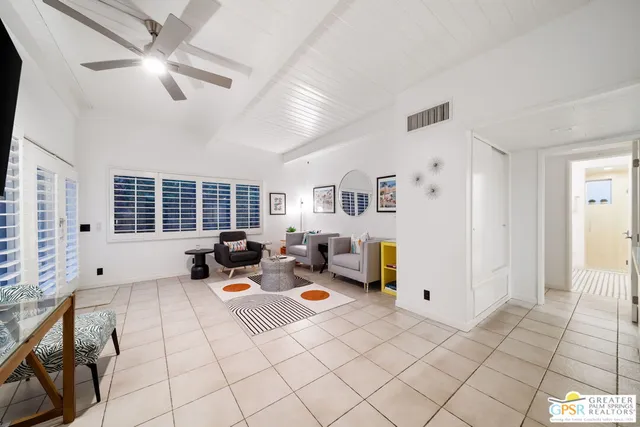 a bedroom with furniture and a flat screen tv