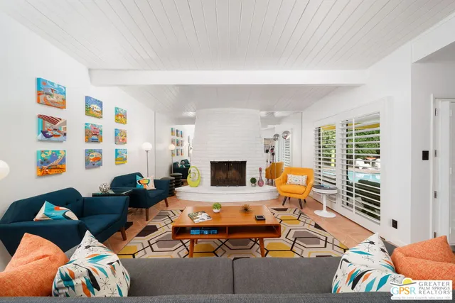 a living room with fireplace furniture and a wooden floor