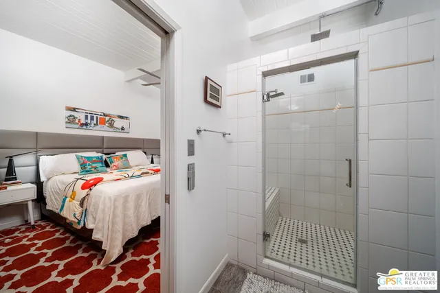 a living room with furniture and a flat tv screen