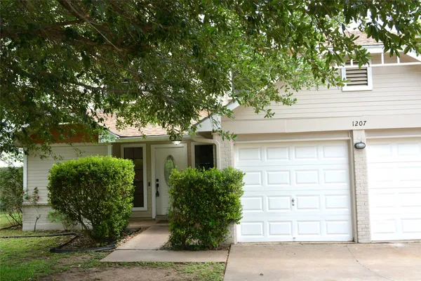 front view of a house and a tree