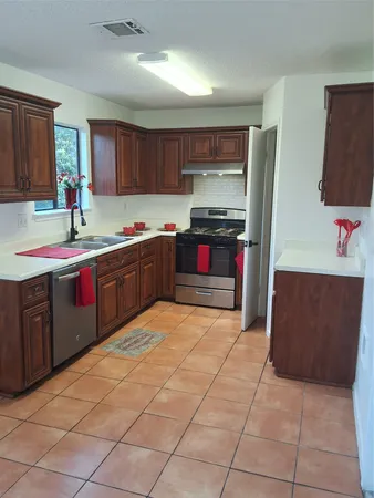 a kitchen with stainless steel appliances granite countertop a sink and cabinets