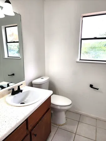 a bathroom with a sink a toilet and mirror