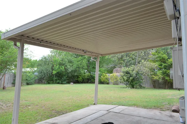 a backyard of a house with a garden and outdoor seating