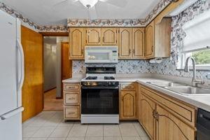 18 Ellen Drive McKees Rocks, PA 15136 - Photo 11 of 23 a kitchen with stainless steel appliances granite countertop a sink stove and refrigerator