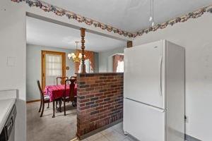 18 Ellen Drive McKees Rocks, PA 15136 - Photo 12 of 23 a hallway with a refrigerator and chandelier