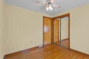18 Ellen Drive McKees Rocks, PA 15136 - Photo 15 of 23 an empty room with a ceiling fan and wooden floor